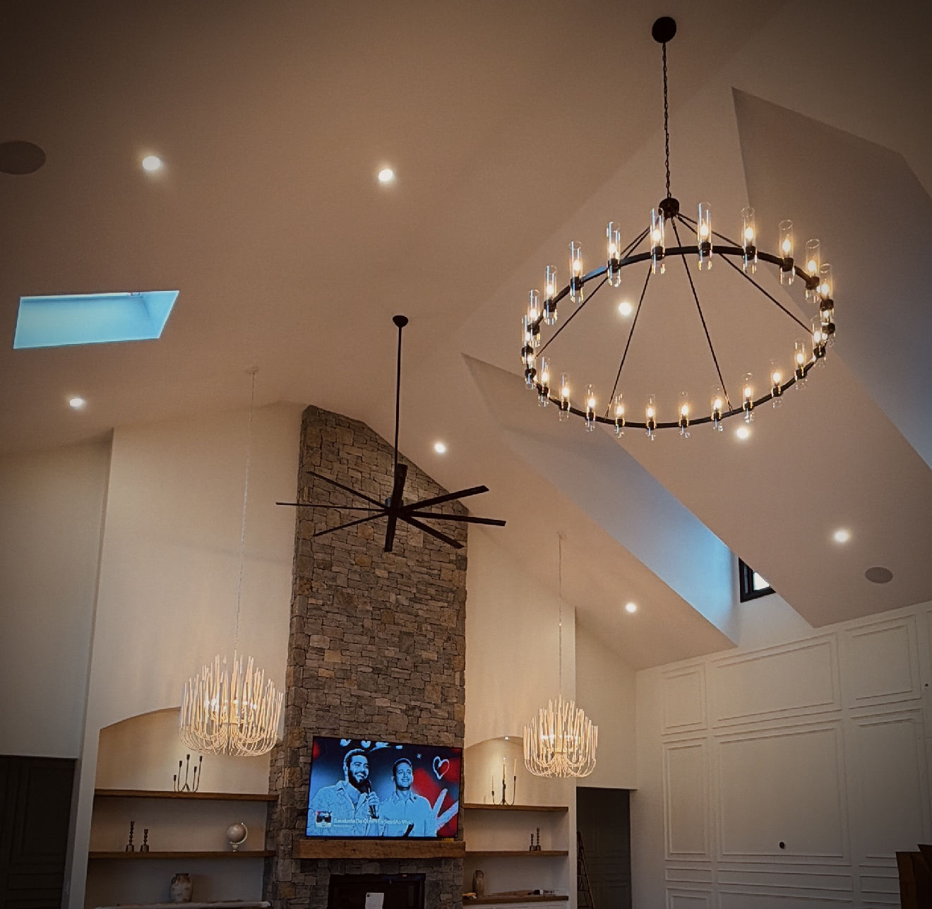 Vaulted living room featuring completed lighting and electrical work